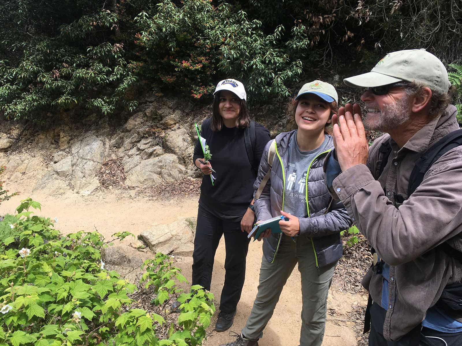 Mariana, Andrea, and California Native Plant Program Director Brett Hall look for the next rapid assessment site for a San Mateo vegetation mapping project. Photo credit: Lucy Ferneyhough, courtesy of University of California Santa Cruz Arboretum.