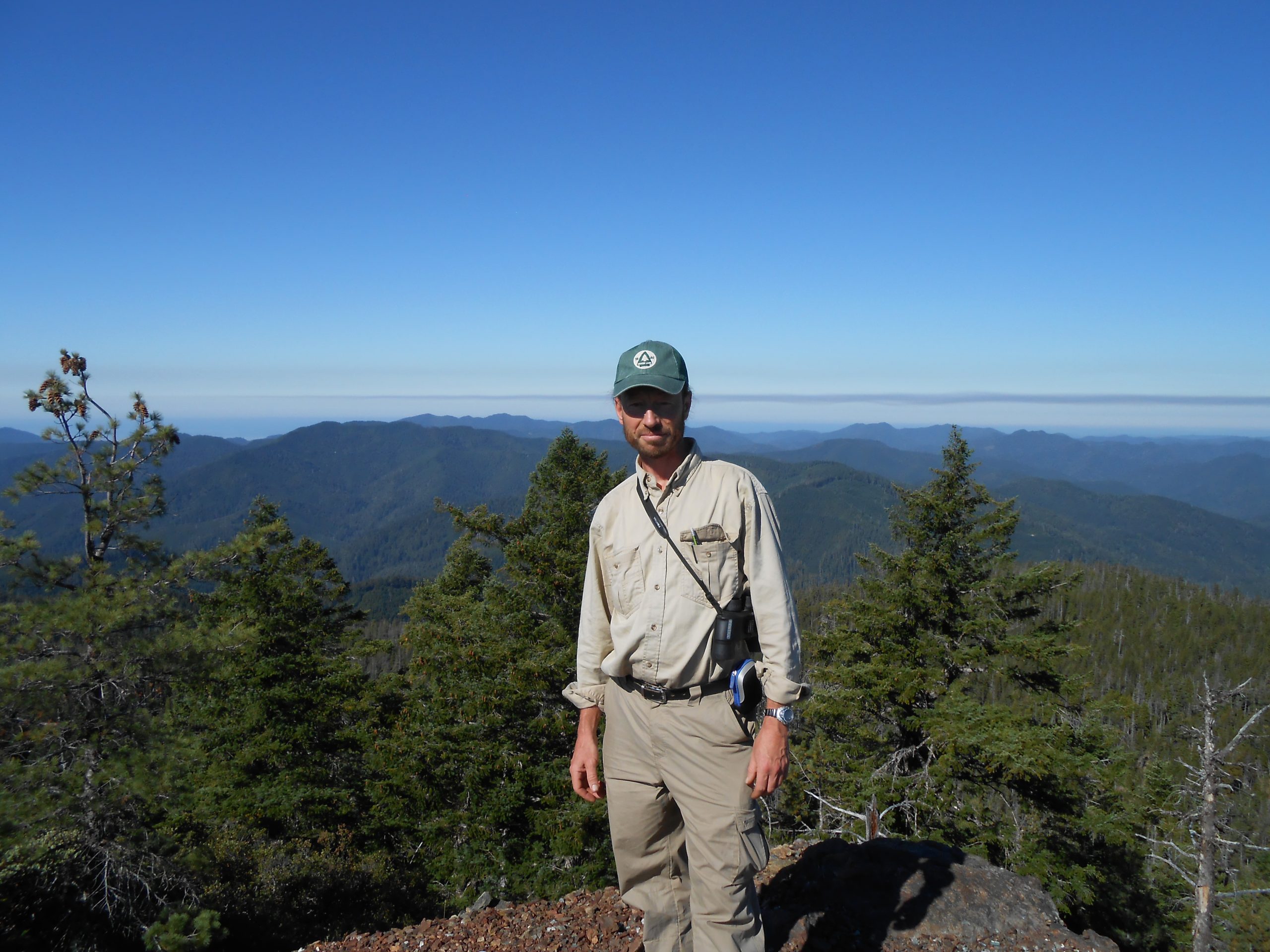 Michael while exploring Iron Mountain in Oregon, and the vulnerable Brewer’s spruce (Picea breweriana) found there.