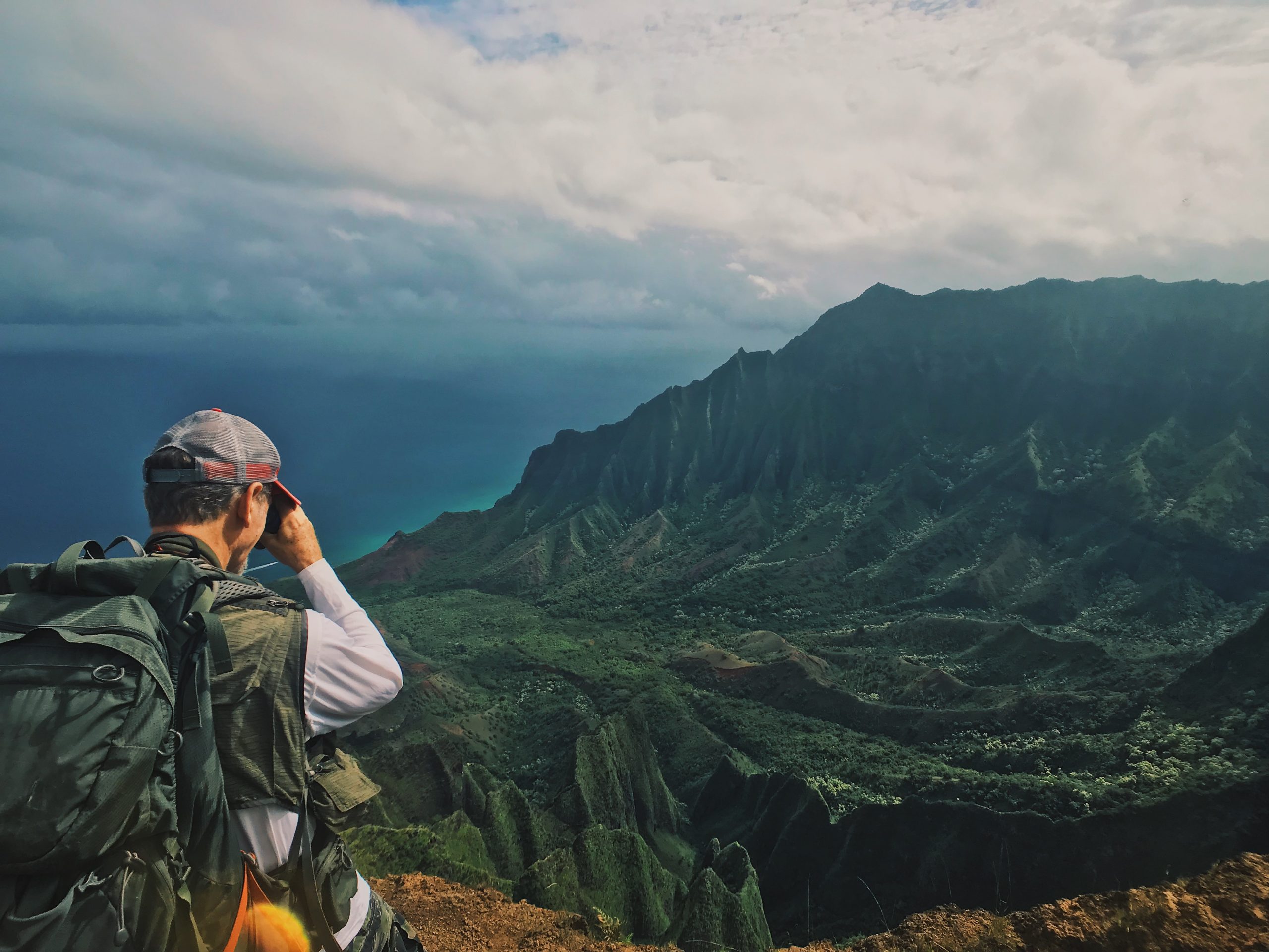 Botanist Ken Wood scopes the rugged terrain of Kaua’i. Even the steepest cliffs can support vegetation, including some rarely seen plant species.