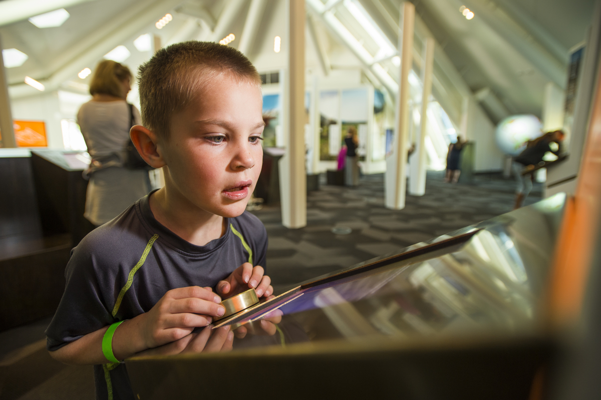 A boy interacts with one of the many technologies providing an engaging outreach experience at the Science Pyramid during Family Science Day.