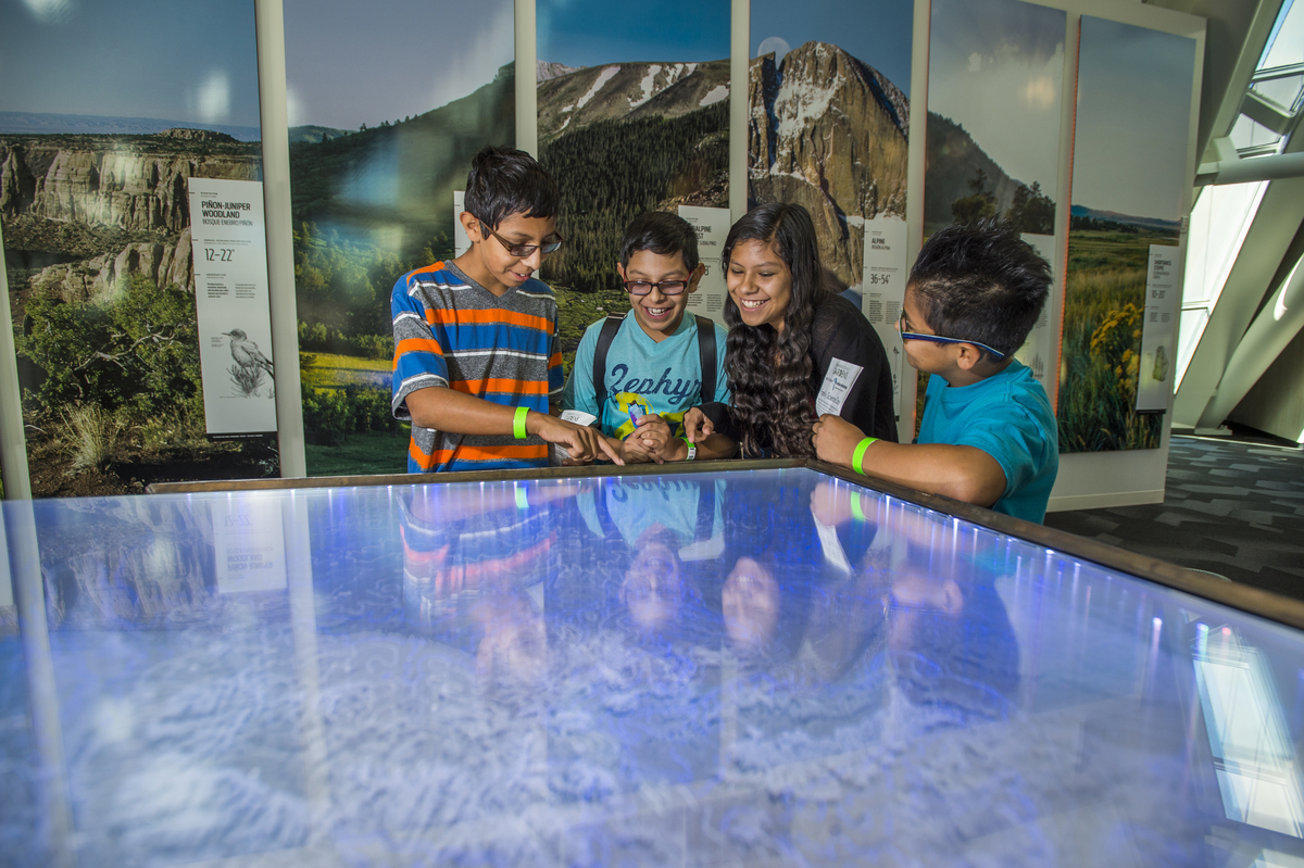 A group of children enjoy exploring the Science Pyramid during Urban Advantage Family Science Day.