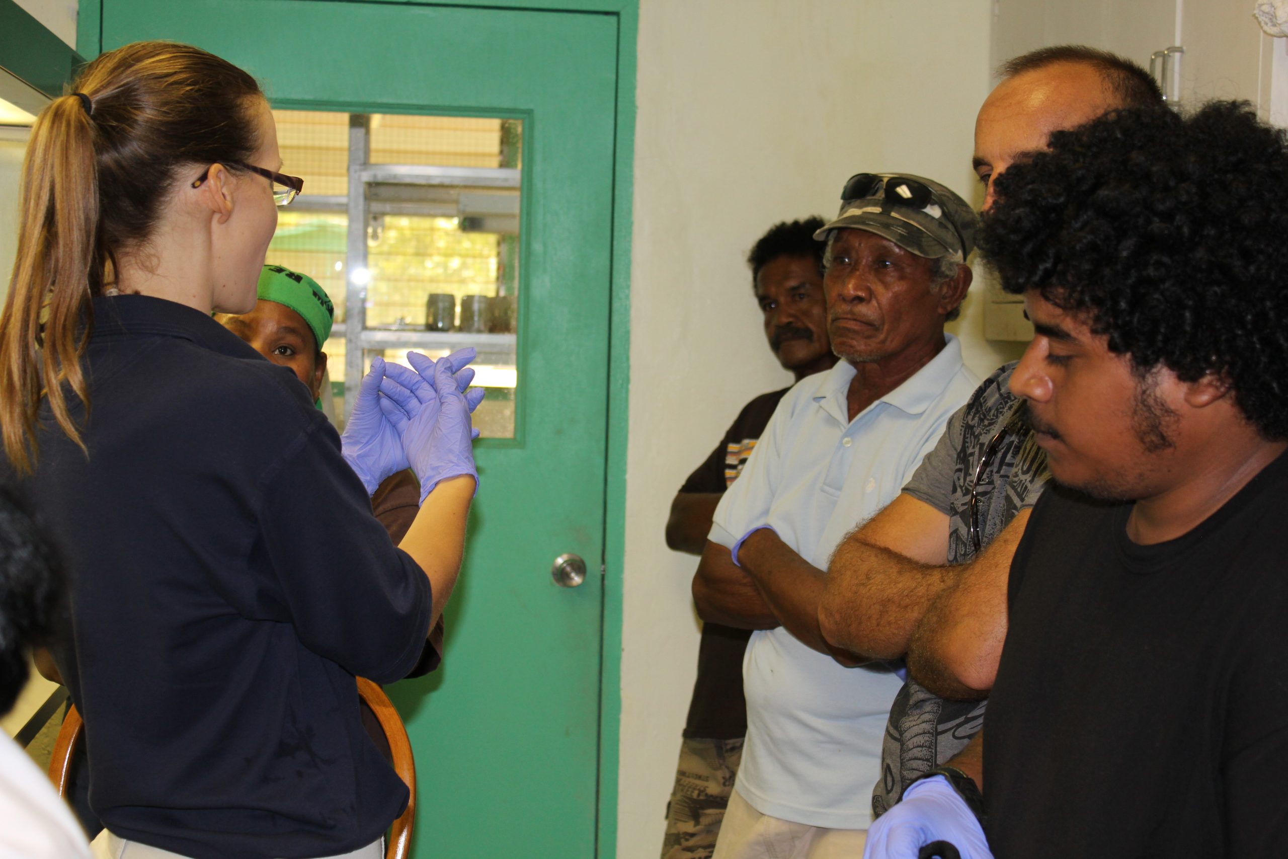 Christy explaining sterile lab techniques in Palau. Photo by Stacy Anderson.