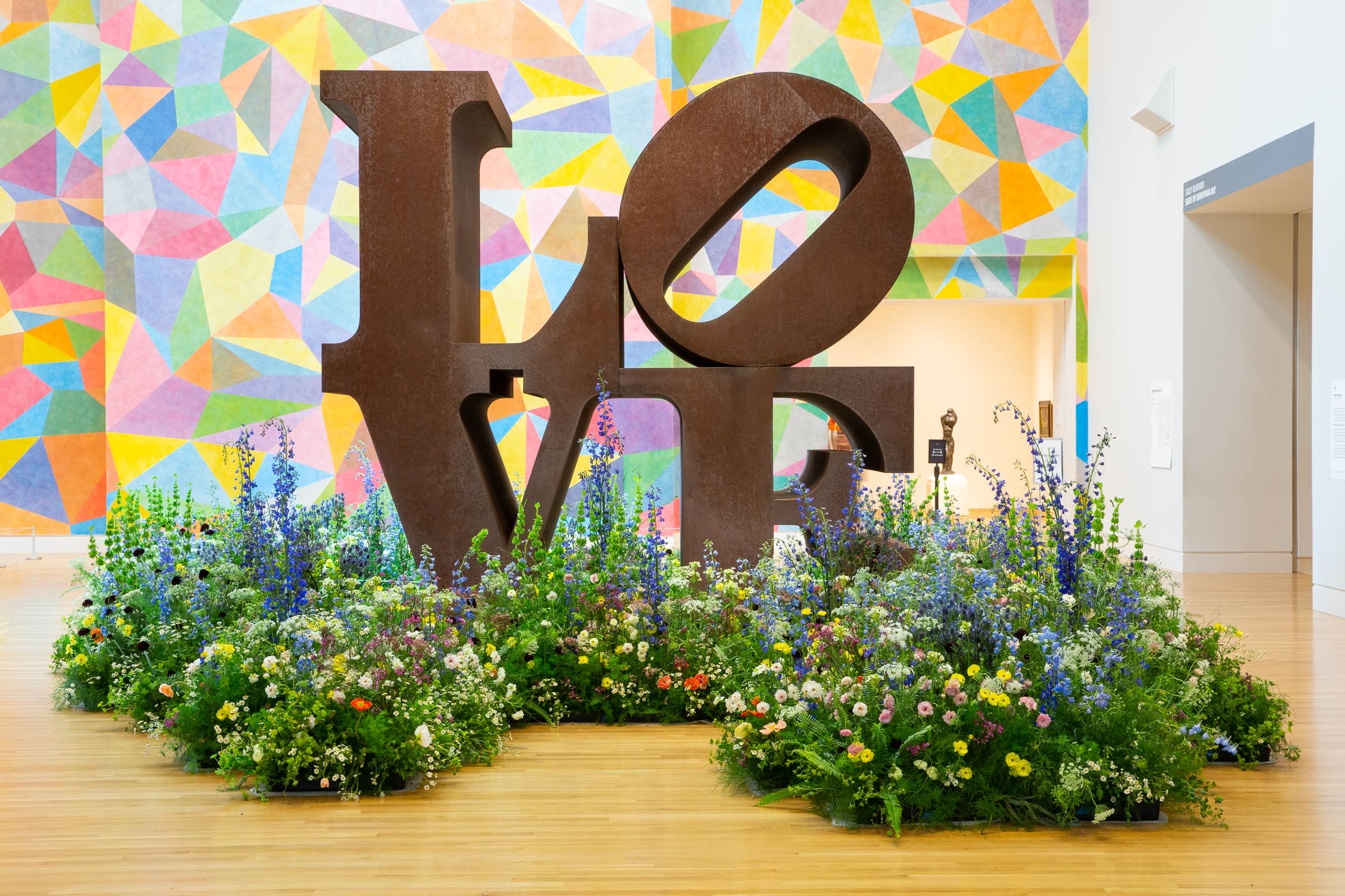 Image of Installation view of Art in Bloom. Robert Indiana (American, 1928–2018), LOVE, 1970, Cor-ten steel, 144 × 144 × 72 in. Indianapolis Museum of Art at Newfields, Gift of the Friends of the Indianapolis Museum of Art in memory of Henry F. DeBoest. Restoration was made possible by Patricia J. and James E. LaCrosse, 75.174 © Morgan Art Foundation / Artists Rights Society (ARS), New York.