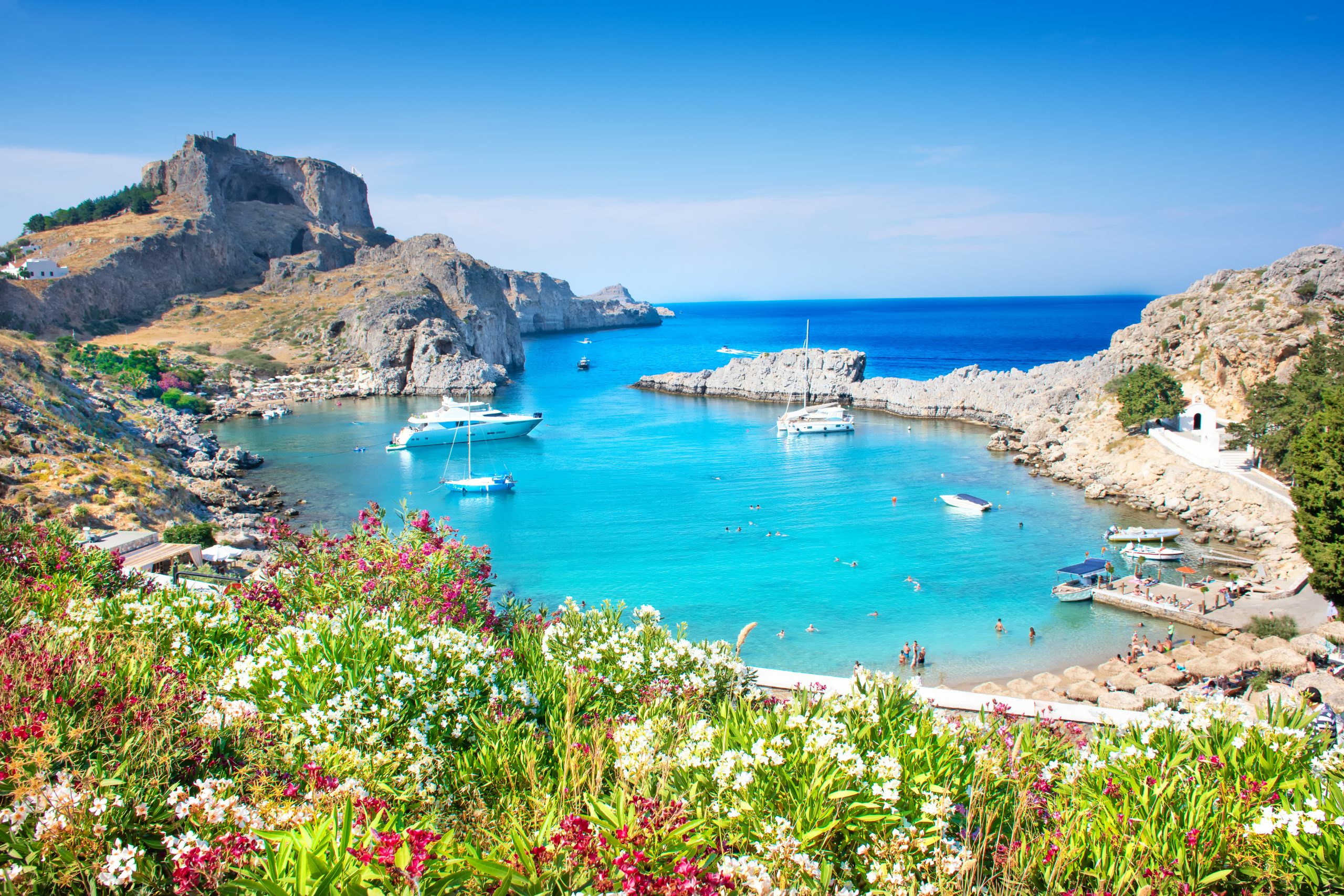 Image of Lindos – panoramic view of St. Paul bay with acropolis of Lindos in background (Rhodes, Greece)